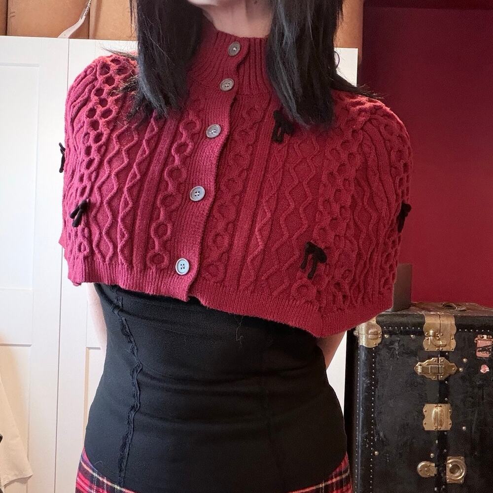 red sweater capelet with black bows